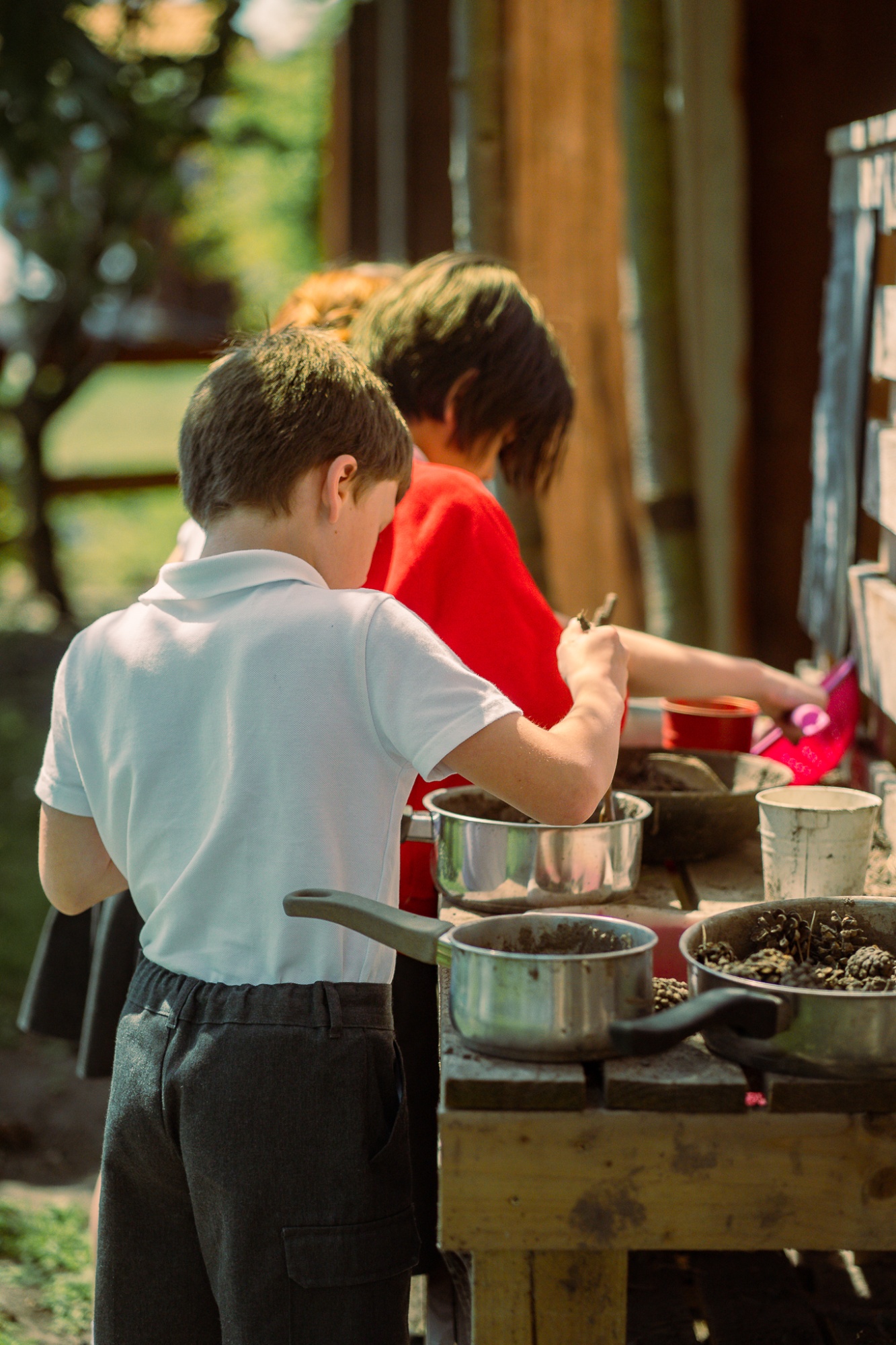 children playing in mud kitchen