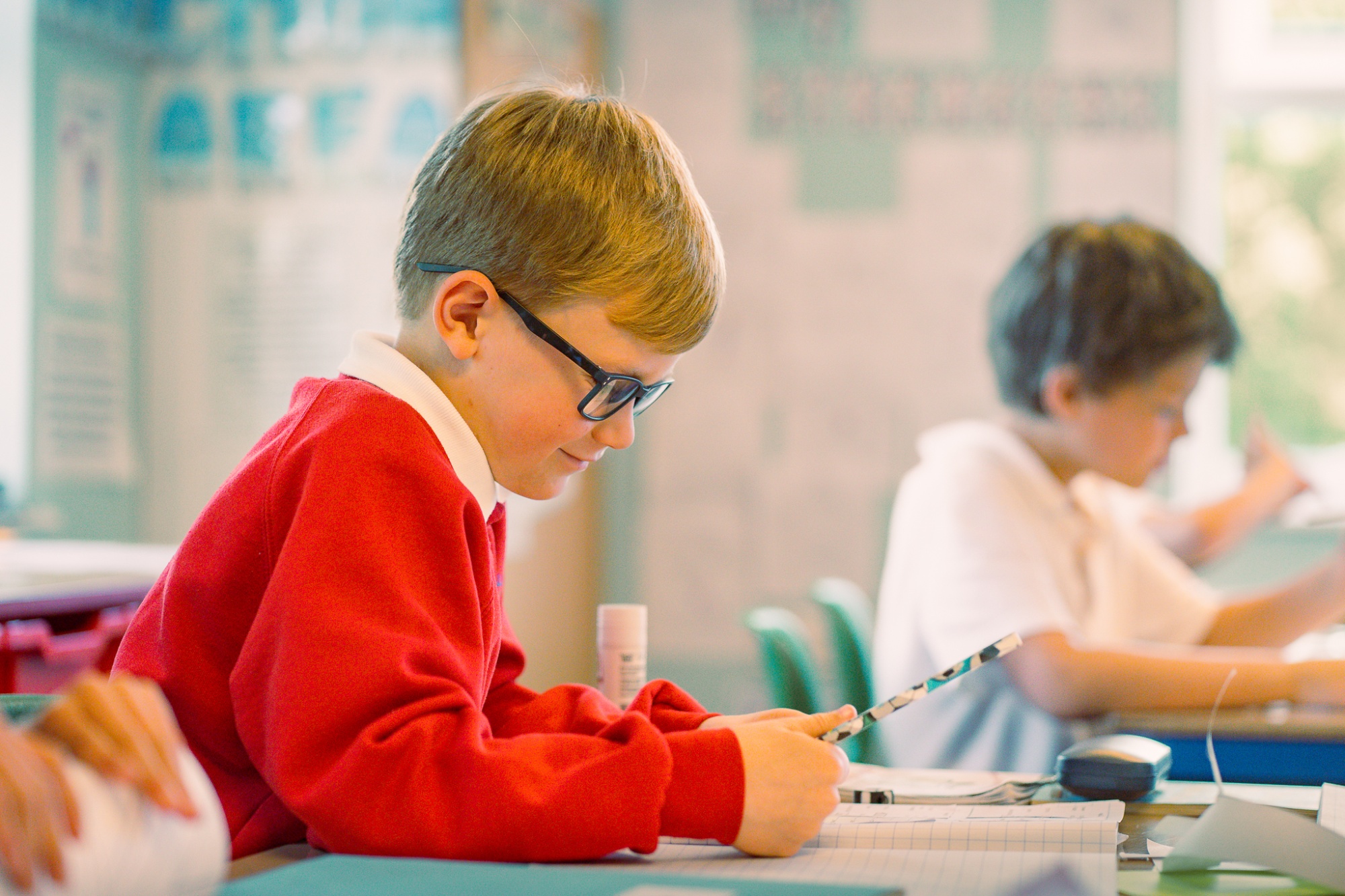 student in lesson writing in text book